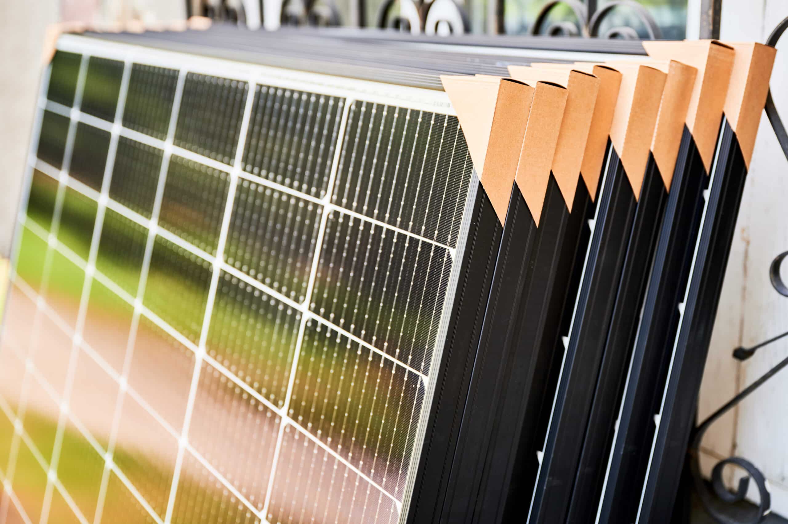 close-up-new-solar-panels-with-protective-cardboar-2024-01-31-17-19-44-utc-scaled.jpg