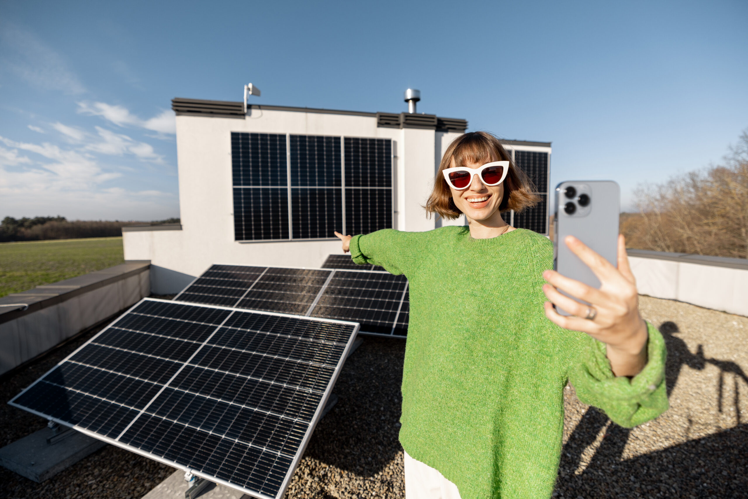 happy-woman-rooftop-with-solar-station-scaled.jpg